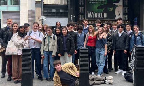 Year 10 students and teachers in front of the Wicked Theatre